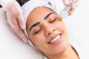 A skincare professional performing JETT Plasma treatment on a patient for skin tightening and rejuvenation